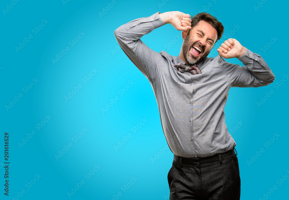 Fototapeta premium Middle age man, with beard and bow tie confident and happy with a big natural smile laughing