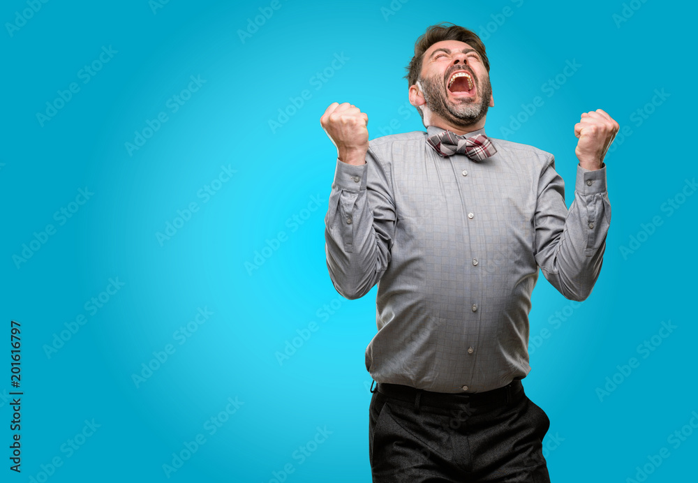 Middle age man, with beard and bow tie happy and excited expressing winning gesture. Successful and celebrating victory, triumphant Middle age man, with beard and bow tie happy and excited expressing winning gesture. Successful and celebrating victory, triumphant