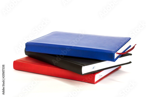 three notebook are stacked on each other on white background