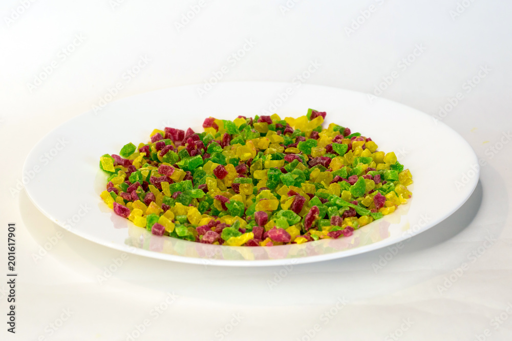 candied fruits close up of different color lie on white plate on white background candied fruits close up of different color lie on white plate on white background