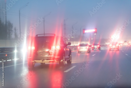 cars on wet road at rainy city evening