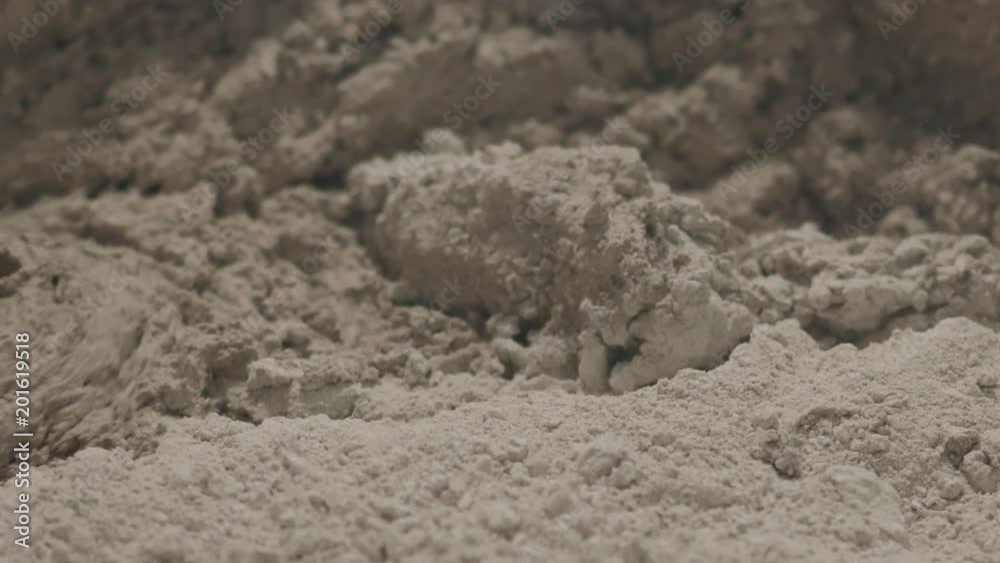 Slow motion pan shot of mixing concrete plaster with electric mixer Slow motion pan shot of mixing concrete plaster with electric mixer