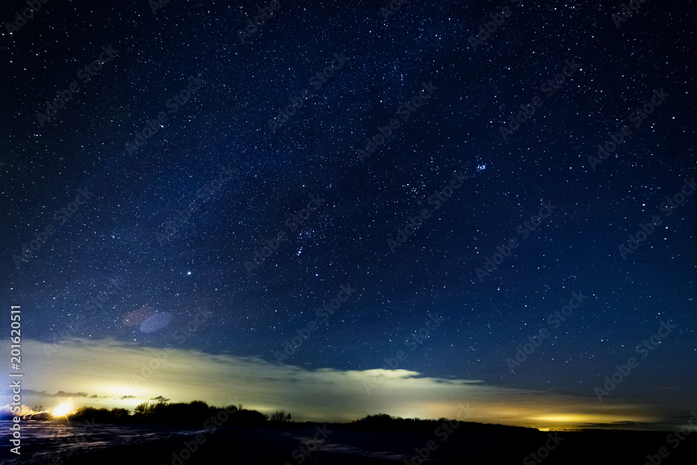 Starry sky above the clouds. Clouds are illuminated by lanterns.