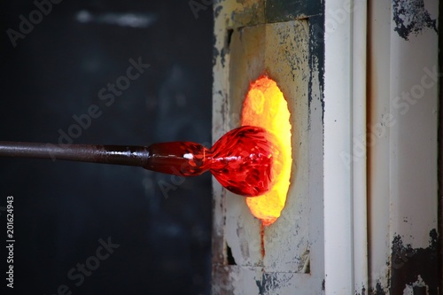 Small Red Vase Being Fed into the Fiery Glass Blower Furnace at the South Florida Renaissance Festival, Quiet Waters Park, Deerfield Beach, Florida photo