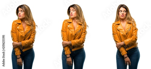 Beautiful young woman irritated and angry expressing negative emotion, annoyed with someone over white background