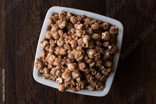 Chocolate Popcorn on dark Wooden Surface.