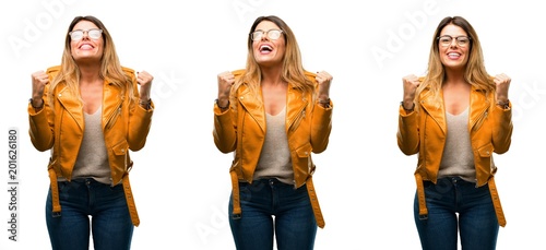 Beautiful young woman happy and excited celebrating victory expressing big success, power, energy and positive emotions. Celebrates new job joyful over white background