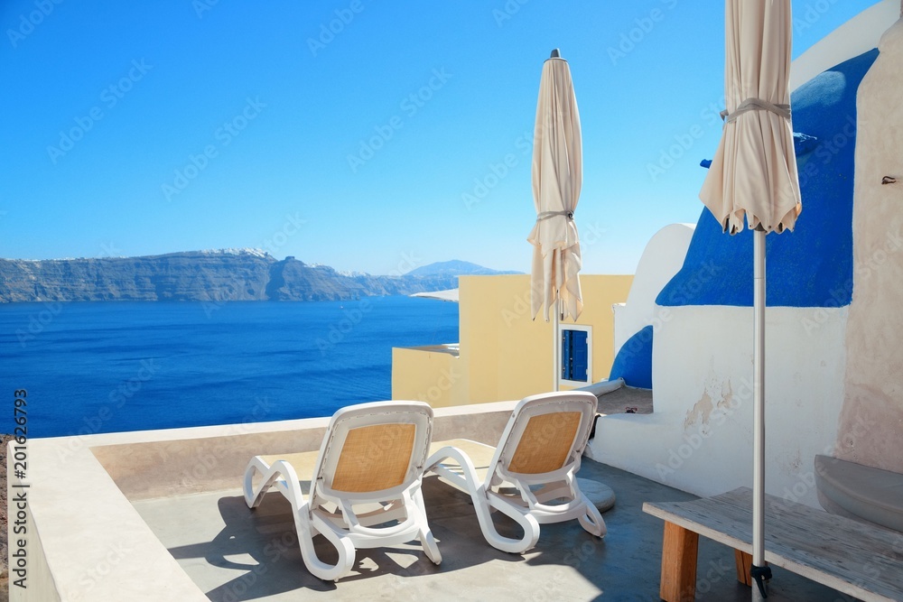 Fototapeta premium Santorini island leisure life with chair and umbrella