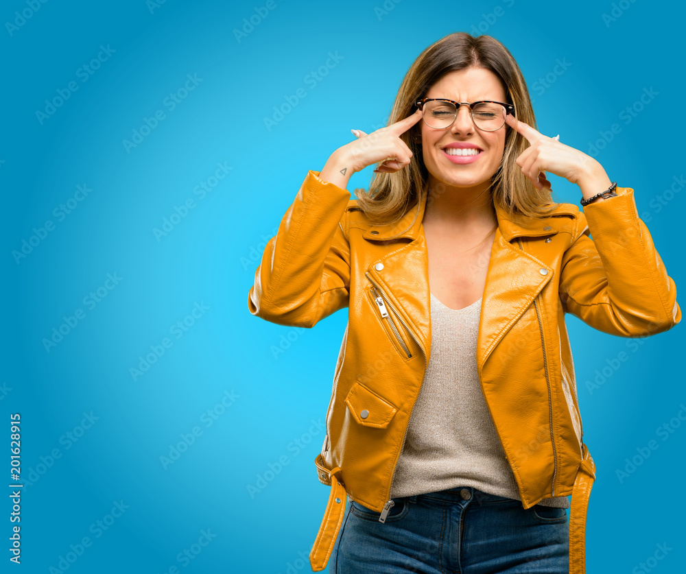 Beautiful young woman doubt expression, confuse and wonder concept, uncertain future, blue background