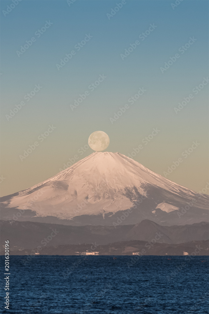 Pearl Fuji , the setting moon meeting the summit of Mt. Fuji. Seen from Yokosuka coast , Kanagawa prefecture.