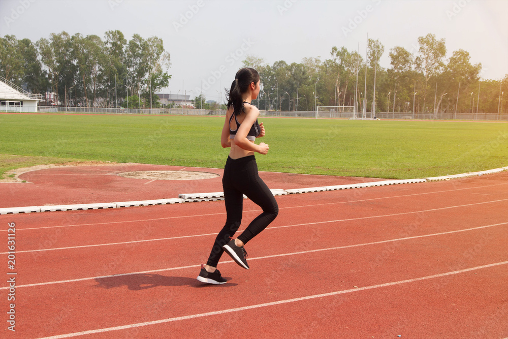 Asian woman sport runner in track stadium Asian woman sport runner in track stadium