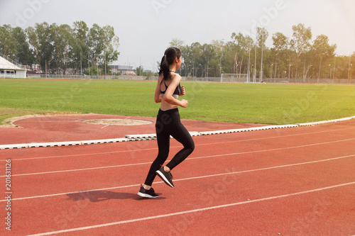 Asian woman sport runner in track stadium 
