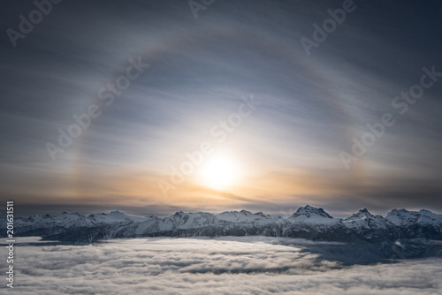 A Halo around the sun over top of mt Begbie at Revelstoke mountain resort