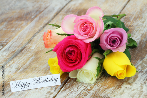 Fototapeta Naklejka Na Ścianę i Meble -  Happy Birthday card with colorful bouquet of roses on rustic wood
