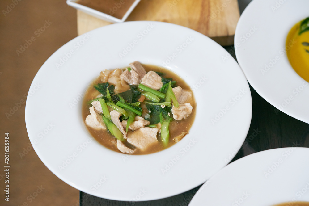 Fried noodle with pork and broccoli on isolated white background top view, called in thai Fried noodle with pork and broccoli on isolated white background top view, called in thai