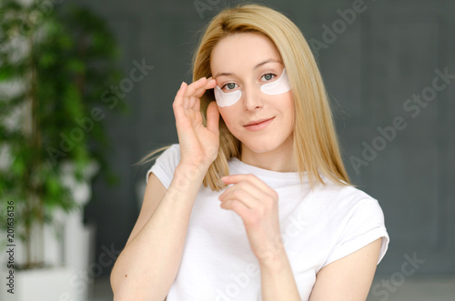 Face Skin Care. Portrait Of Beautiful Smiling Girl Removing White Under Eye Patches From Healthy Fresh Skin. Closeup Of Attractive Sexy Woman With Natural Makeup And Mask On Facial Skin. 