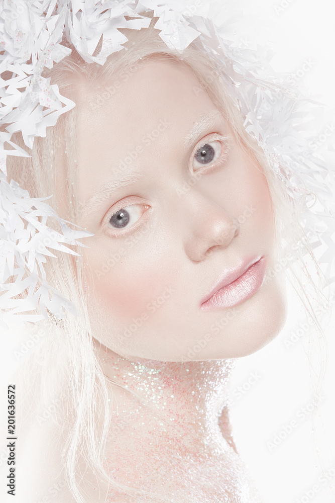 A very delicate portrait of an albino girl, a white background, snowflakes in her hair, sparkles, a magical winter image. Natural make-up, pink lipstick on lips. A very delicate portrait of an albino girl, a white background, snowflakes in her hair, sparkles, a magical winter image. Natural make-up, pink lipstick on lips.