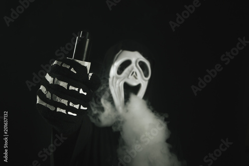 man in a terrible mask and black cloak vape