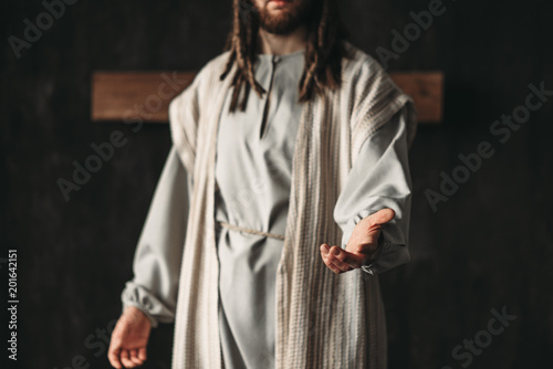 Man in the image of Christ reaching out his hand photo