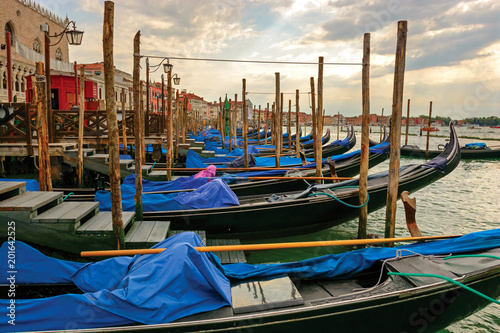 Gondolas at berth, Venice. Perspective view along anchored gondola's row
