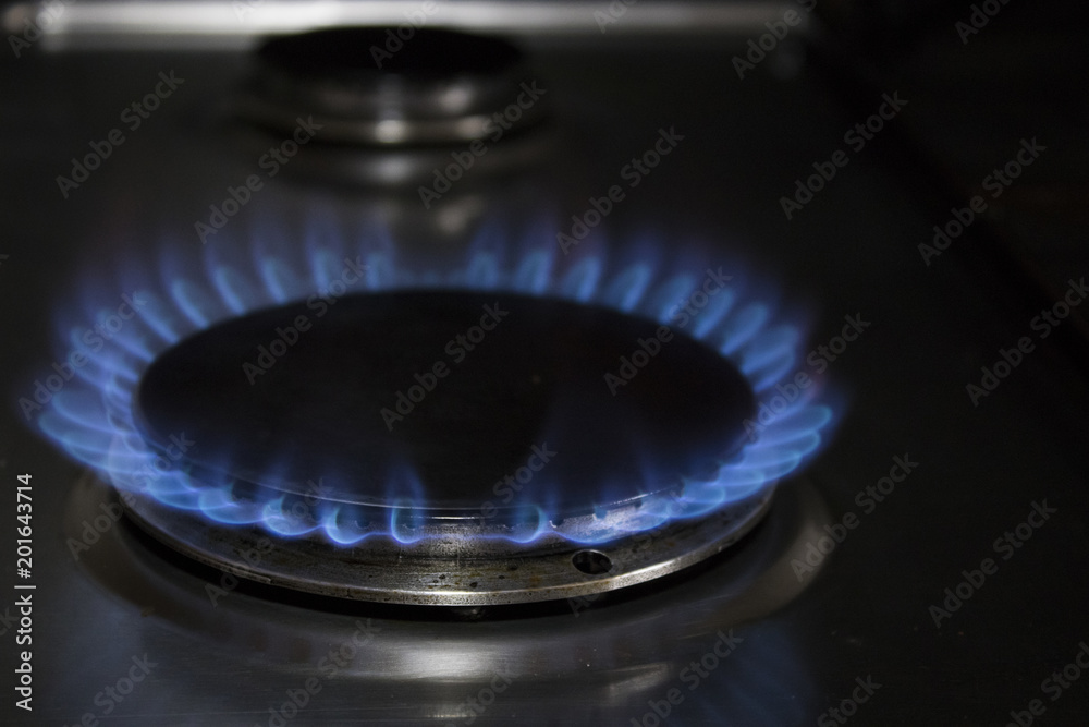Gas cooker and blue flames in a kitchen with black shadows Gas cooker and blue flames in a kitchen with black shadows