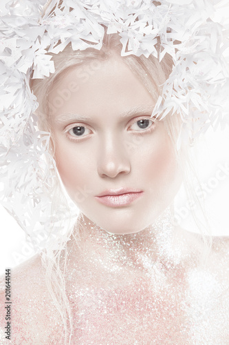 A very delicate portrait of an albino girl, a white background, snowflakes in her hair, sparkles, a magical winter image. Natural make-up, pink lipstick on lips.