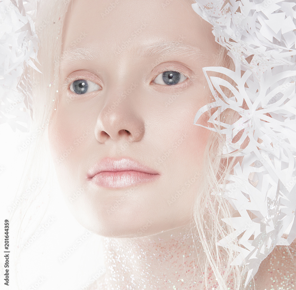 A very delicate portrait of an albino girl, a white background, snowflakes in her hair, sparkles, a magical winter image. Natural make-up, pink lipstick on lips. A very delicate portrait of an albino girl, a white background, snowflakes in her hair, sparkles, a magical winter image. Natural make-up, pink lipstick on lips.