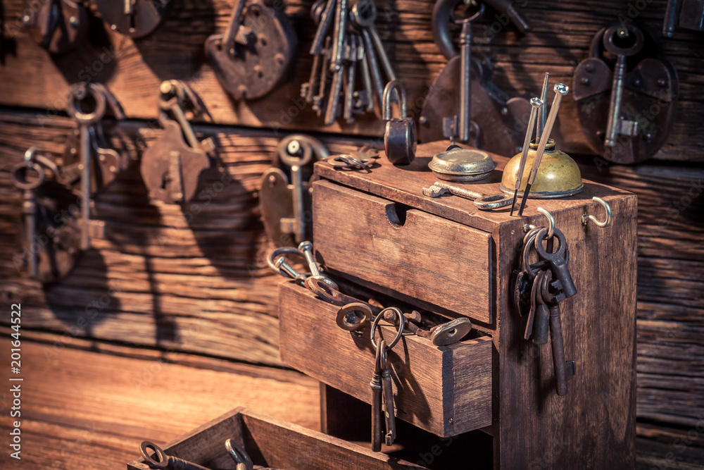 Wooden box with keys and locks in locksmiths workshop