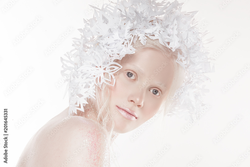 A very delicate portrait of an albino girl, a white background, snowflakes in her hair, sparkles, a magical winter image. Natural make-up, pink lipstick on lips.