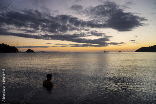 Little boy looking at beautiful sunset