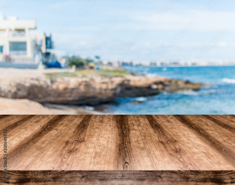 Wooden empty table board in front of blurred background. Can be used for display or montage any product. Mock up for display your product.