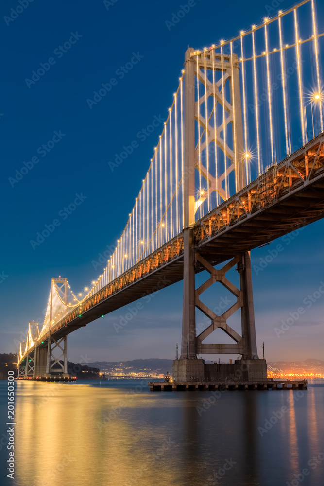 Under the Bay Bridge Light Reflections. The Embarcadero, San Francisco, California, USA.