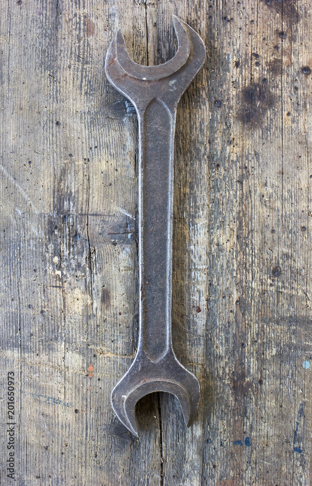 Old, dirty wrench against wooden plank. Tool series. Old, dirty wrench against wooden plank. Tool series.