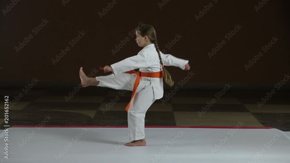 Direct kicks the girl is training in karategi Direct kicks the girl is training in karategi