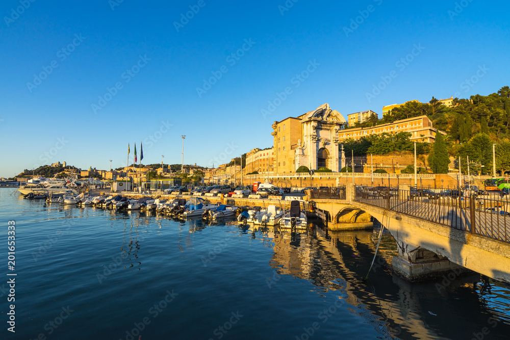 Seascape with Ancona harbor and boat docked at sunset, Marche, Italy