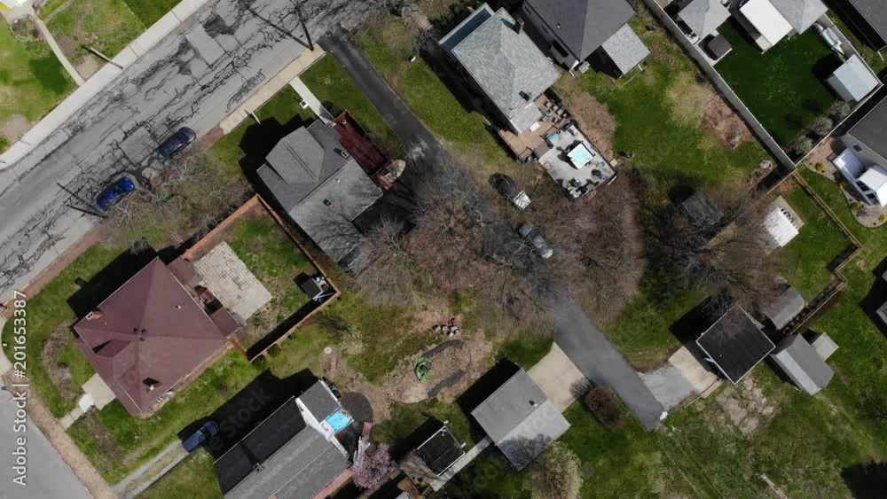 A daytime late winter bird's eye angled aerial view straight down on a typical residential neighborhood in a Western Pennsylvania small town. Pittsburgh suburbs. A daytime late winter bird's eye angled aerial view straight down on a typical residential neighborhood in a Western Pennsylvania small town. Pittsburgh suburbs.
