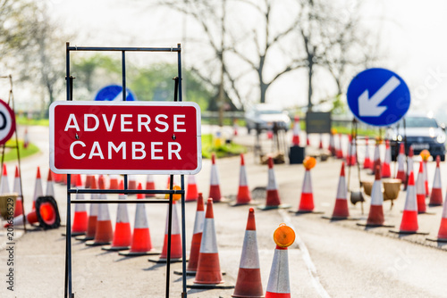 Fototapeta Naklejka Na Ścianę i Meble -  Adverse Camber Roadworks sign on UK motorway with cones