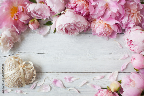 Fototapeta Naklejka Na Ścianę i Meble -  Background with pink peonies and a lacy heart for congratulations