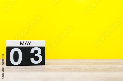 May 3rd. Day 3 of may month, calendar on office table with yellow background. Spring time