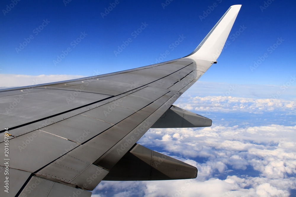 aeroplane wing with blue sky in the distance