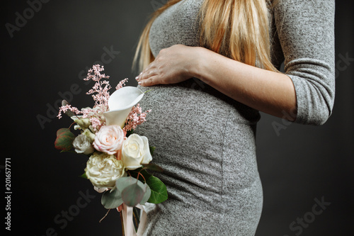 Woman with flowers. pregnancy