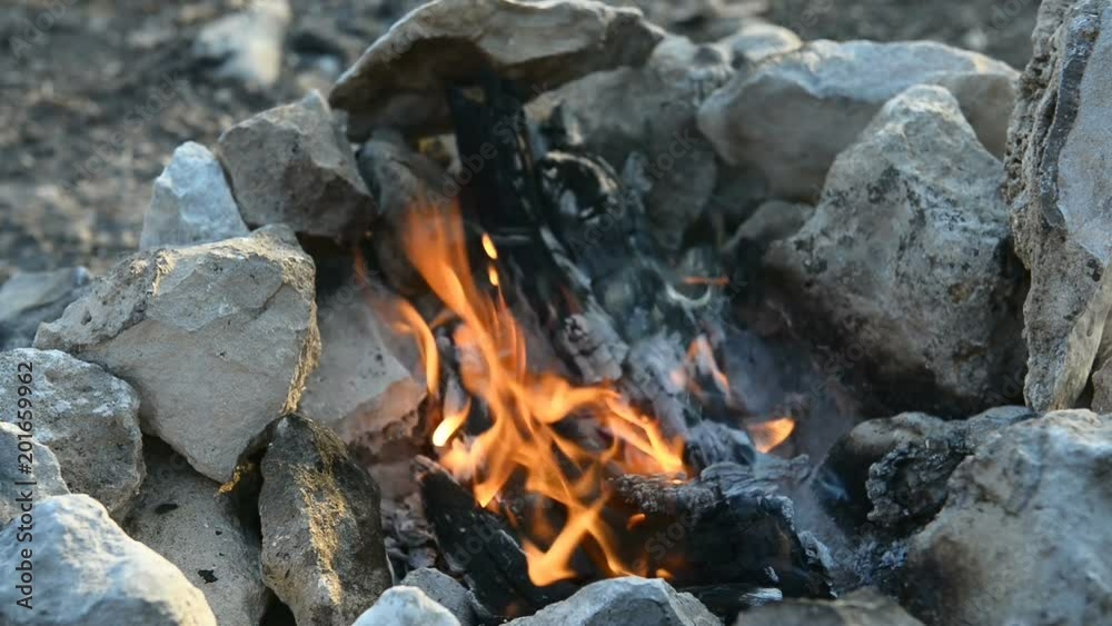 Bonfire in a camp-fire of stones outdoors Bonfire in a camp-fire of stones outdoors