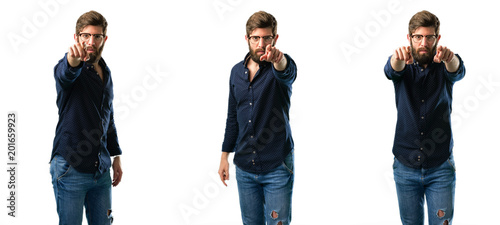 Young man with beard pointing to the front with finger isolated over white background