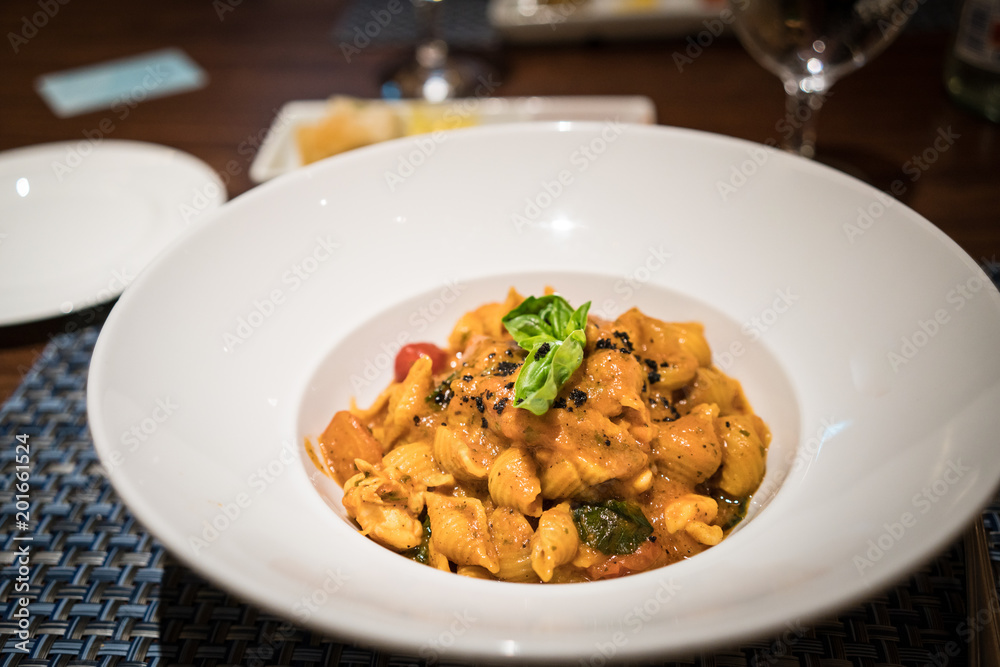 A bowl of delicious lobster pasta in a restaurant. A bowl of delicious lobster pasta in a restaurant.