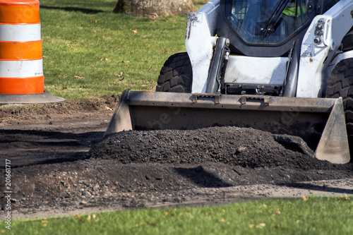 Compact excavator and road resurfacing work
