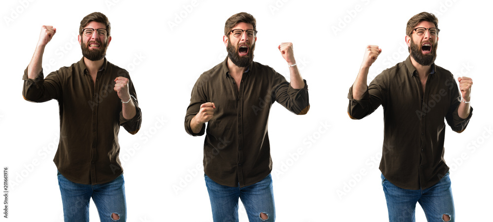Young man with beard happy and excited celebrating victory expressing big success, power, energy and positive emotions. Celebrates new job joyful isolated over white background Young man with beard happy and excited celebrating victory expressing big success, power, energy and positive emotions. Celebrates new job joyful isolated over white background