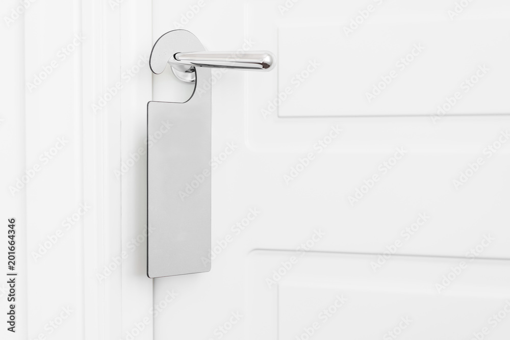 Door knob with empty label on a door handle for your text. Empty white