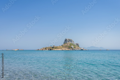 Kos Island, Kastri, Dodecanese, Greece: Beautiful sunny coast view to greek mediterranean blue sea with crystal clear water at ancient traditional place or old temple church area near a small islet