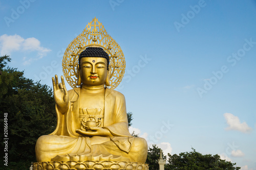 Large golden Buddha statue at Sanbanggulsa temple, Sanbang-ro, Jeju Island, South Korea photo