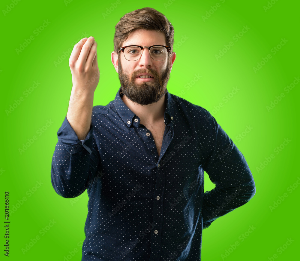 Young hipster man with big beard angry gesturing typical italian gesture with hand, looking to camera over green background Young hipster man with big beard angry gesturing typical italian gesture with hand, looking to camera over green background